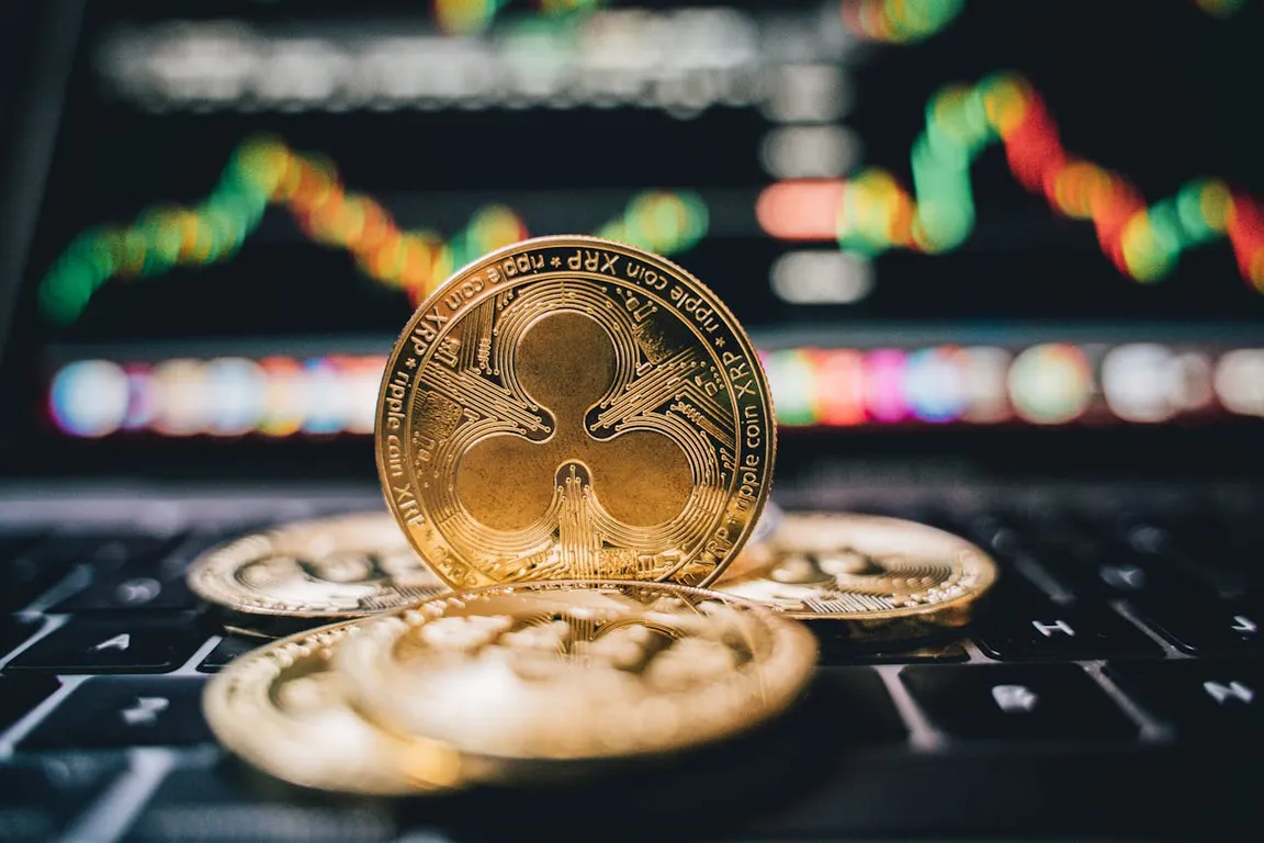 An XRP coin on a laptop