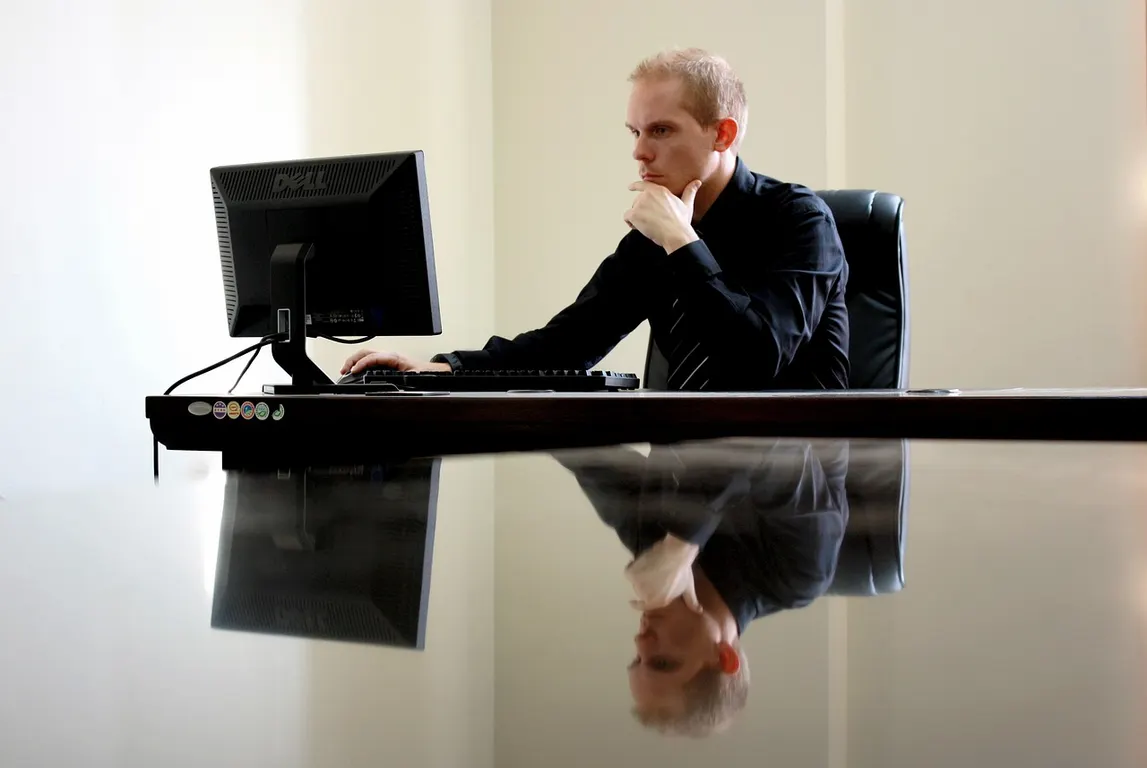 a man sitting in front of a computer