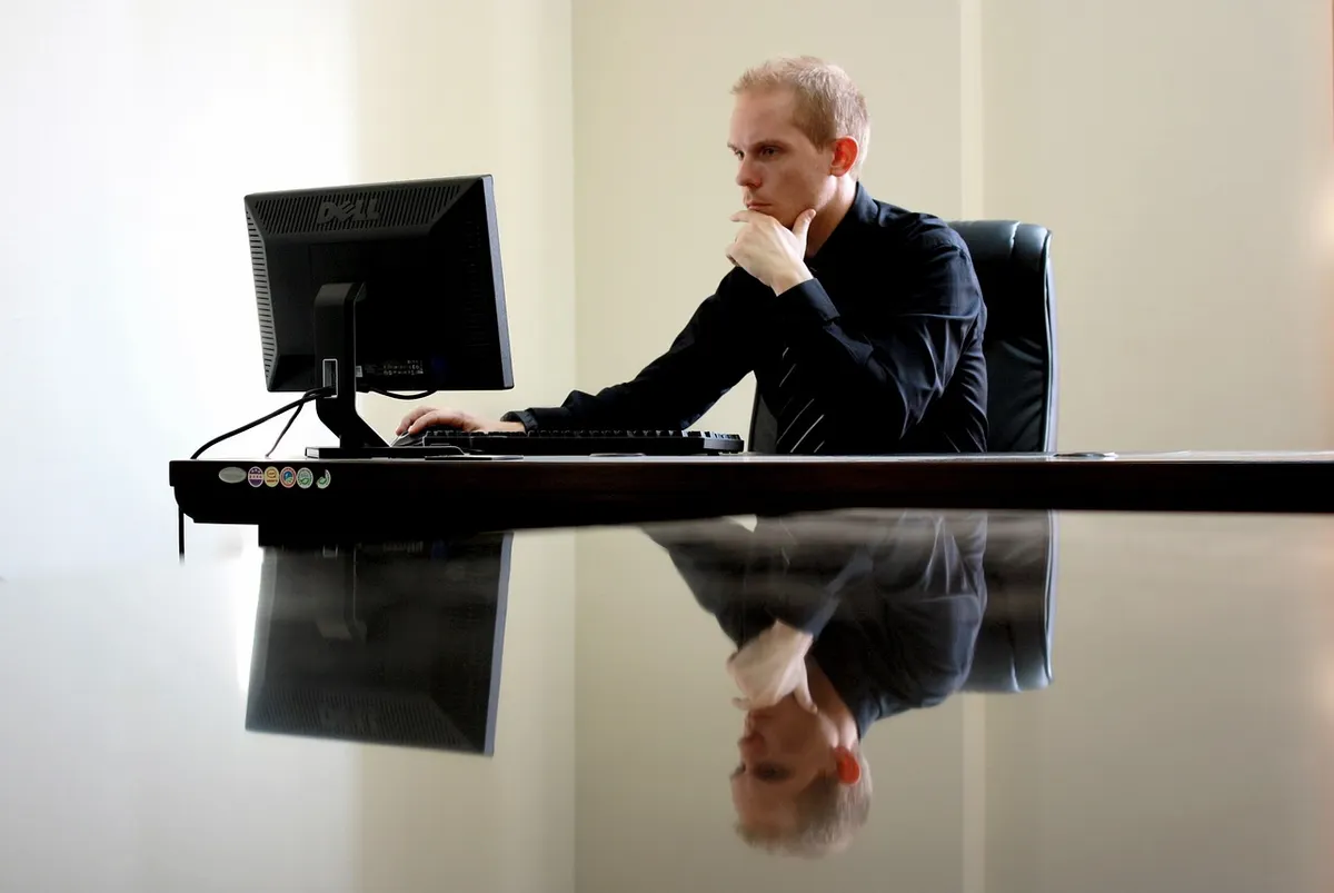 a man sitting in front of a computer