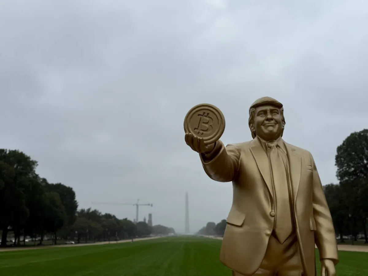 Statue of Trump holding a Bitcoin